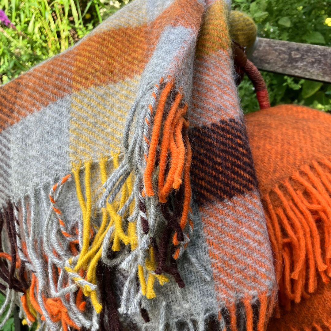 gotland wool blankets and throws folded on a bench