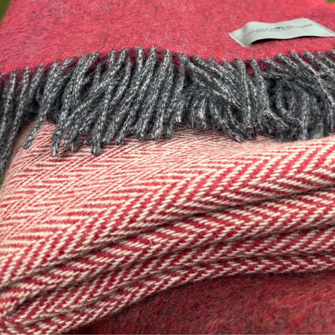 red wool throws against a green background