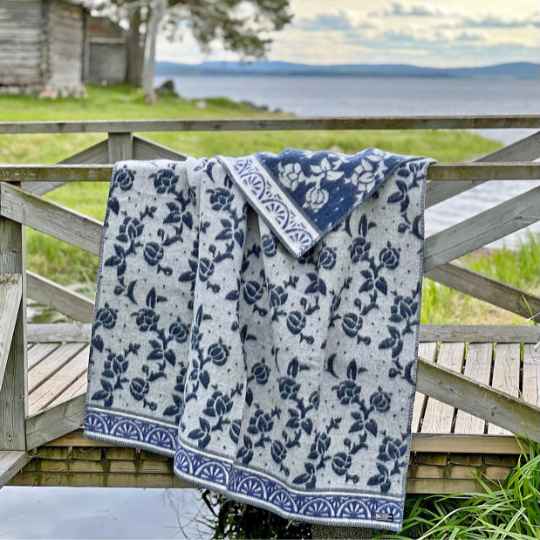 blue jugend wool blanket over a wooden fence
