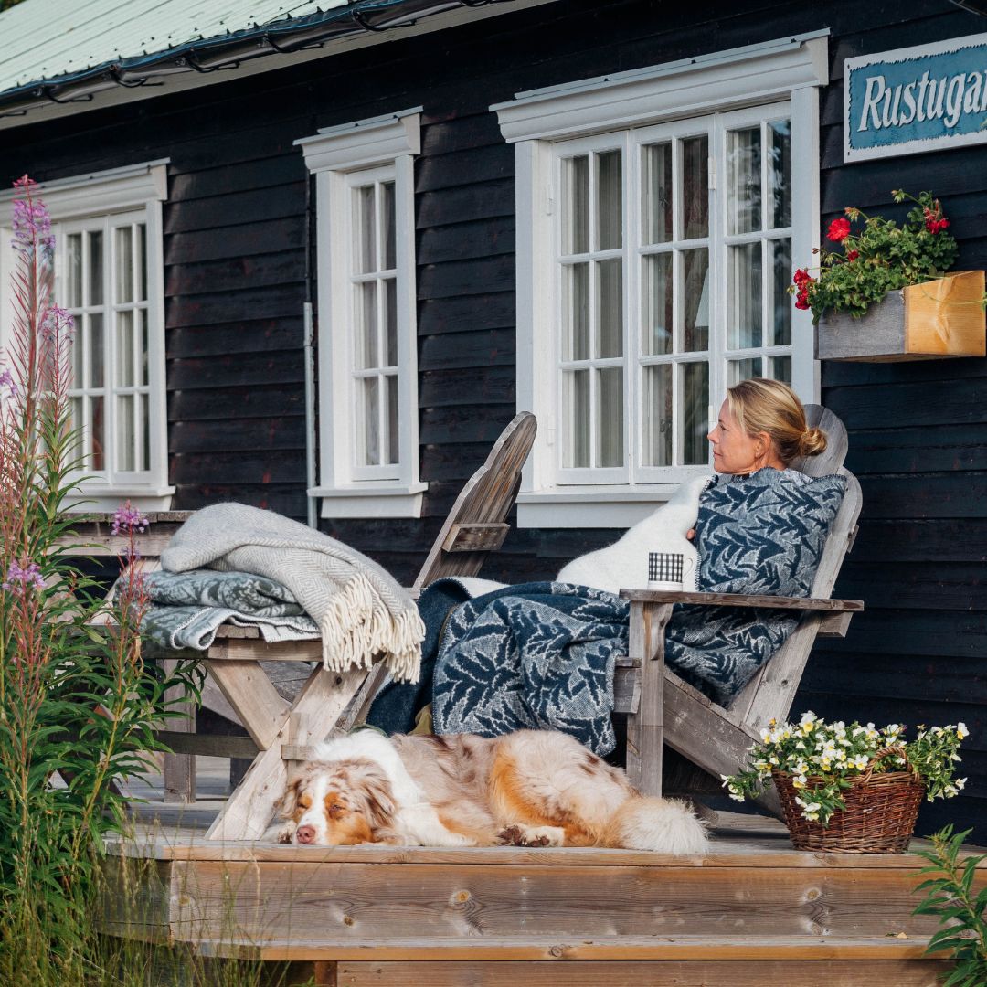a person wrapped in a wool blanket sat in a chair relaxing