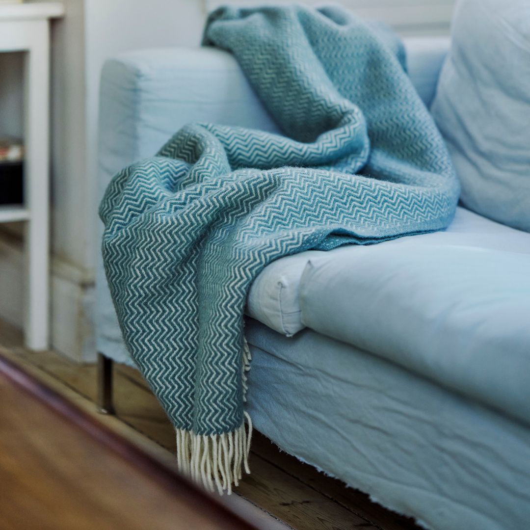 blue wool throw on a white sofa
