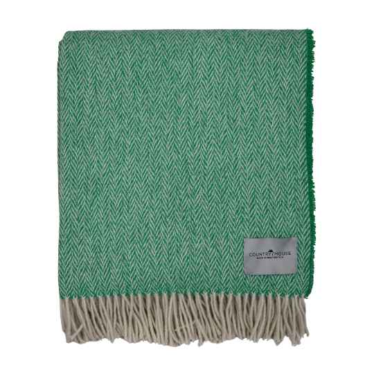 green herringbone wool throw on a white background