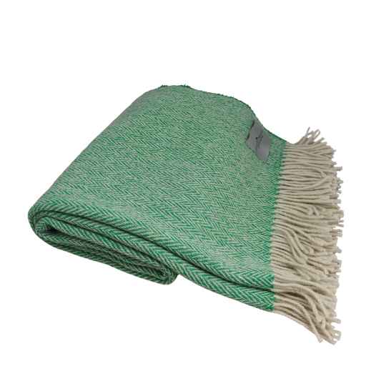 Green woven blanket with white fringe on a white background