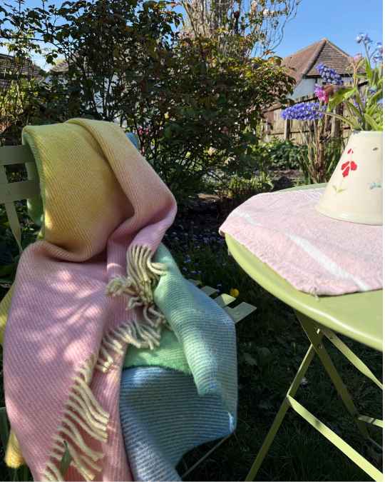 Aurora pastel dream in a Spring garden on a green table and chairs