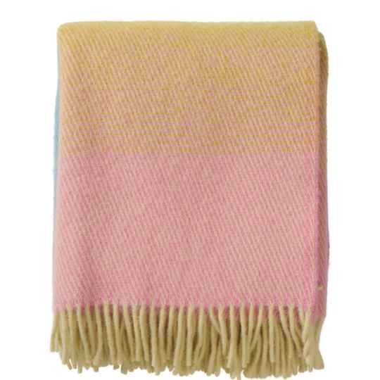 aurora pastel Pink and yellow plaid blanket with fringed edge on a white background