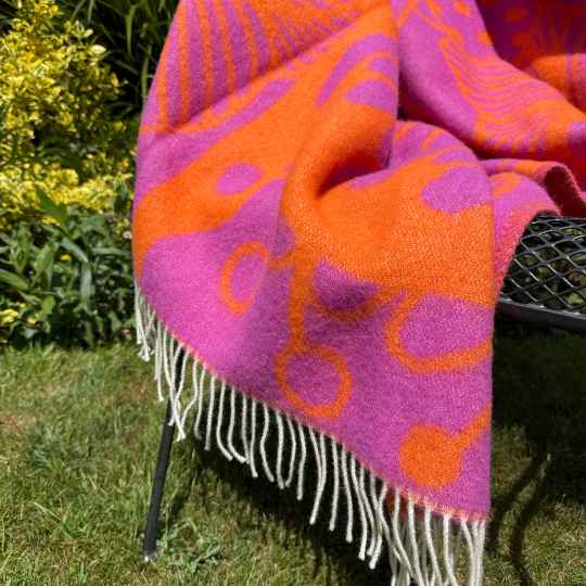 Blomranka wool throw blanket on a chair