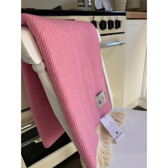 pink wool throw blanket on the back of a chair in a kitchen 