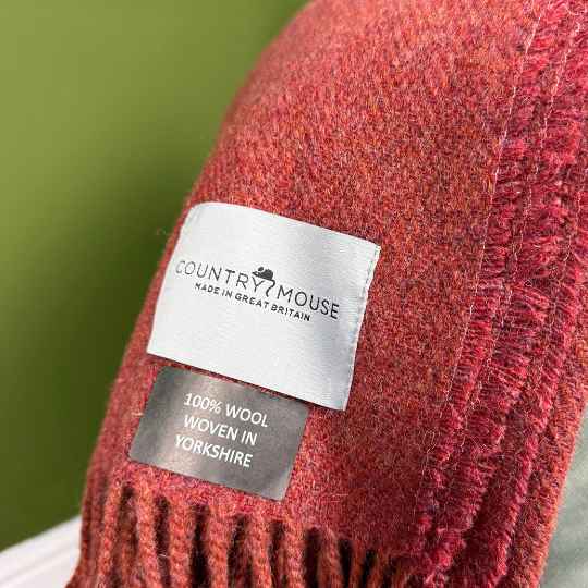 fired earth terracotta wool throw with a woven label 