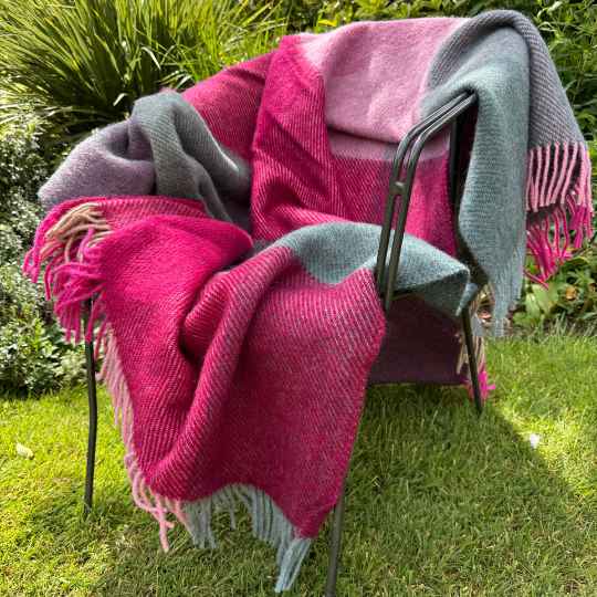 Gotland Pink Checked wool throw blanket on a chair