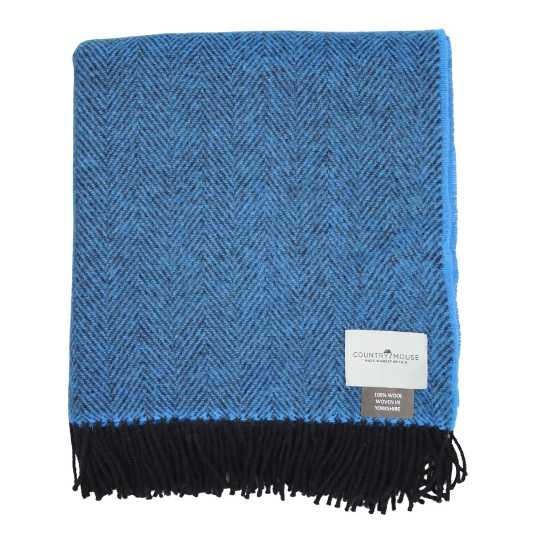 Blue and black herringbone patterned throw blanket with a brand label on a white background