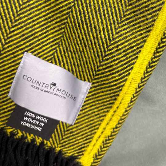 lichen herringone wool throw with a country mouse label