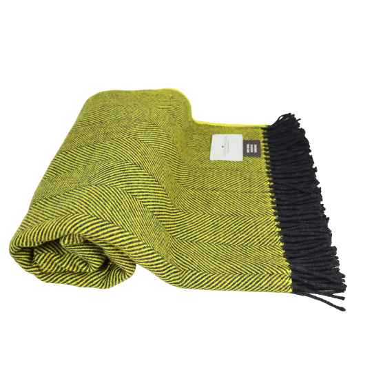 Yellow woven blanket with black fringe on a white background