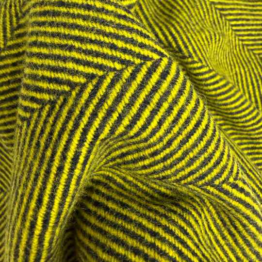 Close-up of yellow and black herringbone wool throw