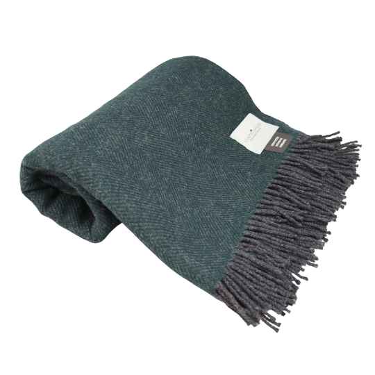 Green blanket with fringes on a white background