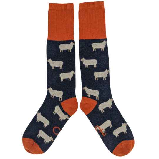 Pair of socks with sheep pattern and orange accents on a white background