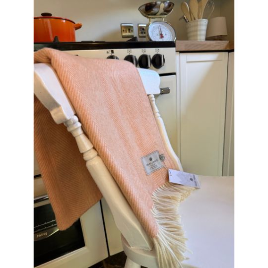 sherbert orange wool throw on a chiar in a kitchen