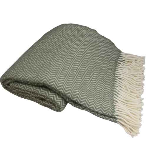 Green and white herringbone patterned blanket with fringed edge on a white background