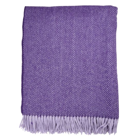 A folded purple woven throw blanket with a herringbone pattern and fringed edges, shown against a plain white background.