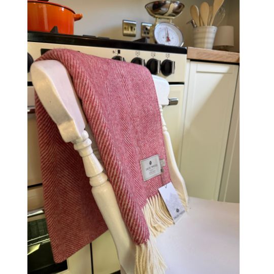 raspberry coloured wool throw blanket on a chair in a  kitchen