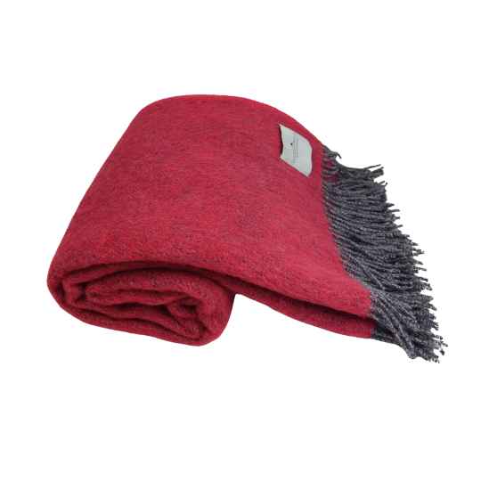 Folded raspberry pink wool blanket with gray fringe on a white background background