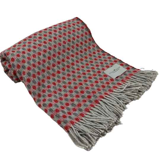 red and french grey recycled wool throw rolled up.