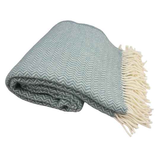 Folded blue blanket with zigzag pattern and white fringe on a white background