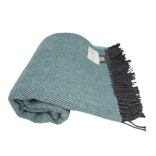 Folded blue blanket with black fringe on a white background