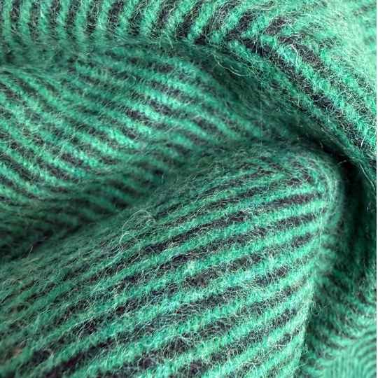 Close-up of greenwool throw with a textured pattern