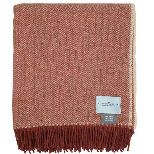 warm clay herringbone wool throw on a white background