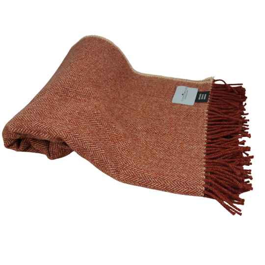 warm clay woven blanket with fringes on a white background