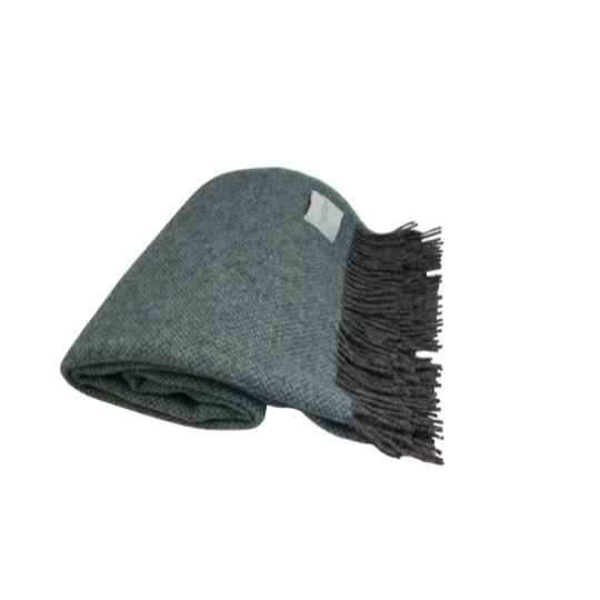 Folded blue blanket with fringes on a white background