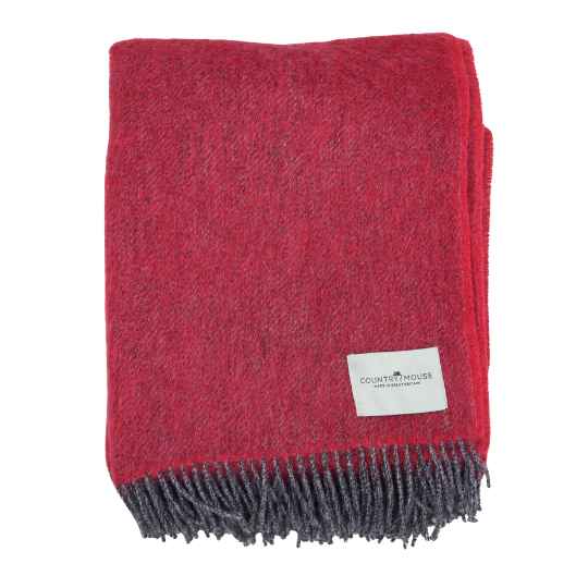 Baked cherry red wool throw on a white background